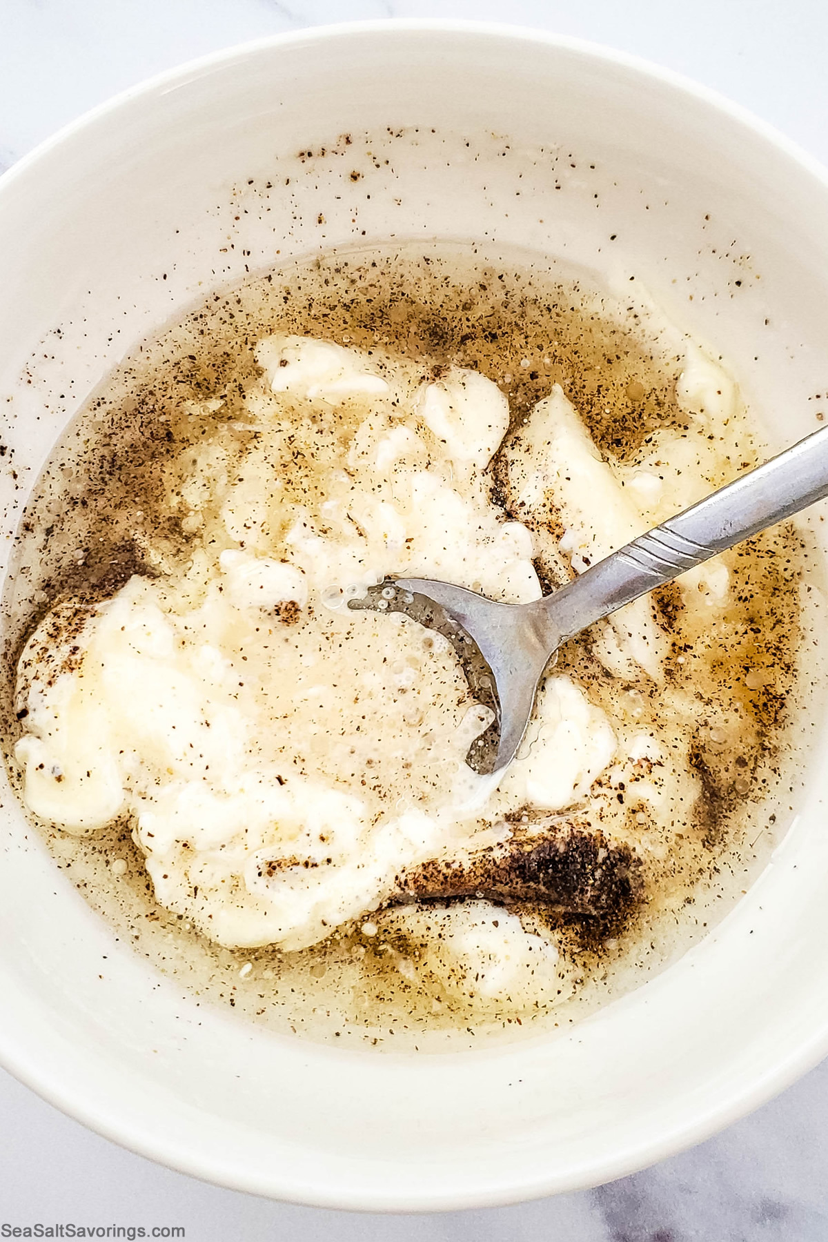 mixing ingredients in a bowl to make dressing