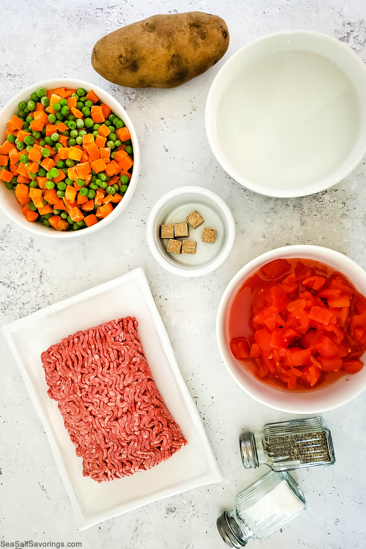 beef vegetable soup ingredients including mixed vegetables, potato, ground beef and tomatoes