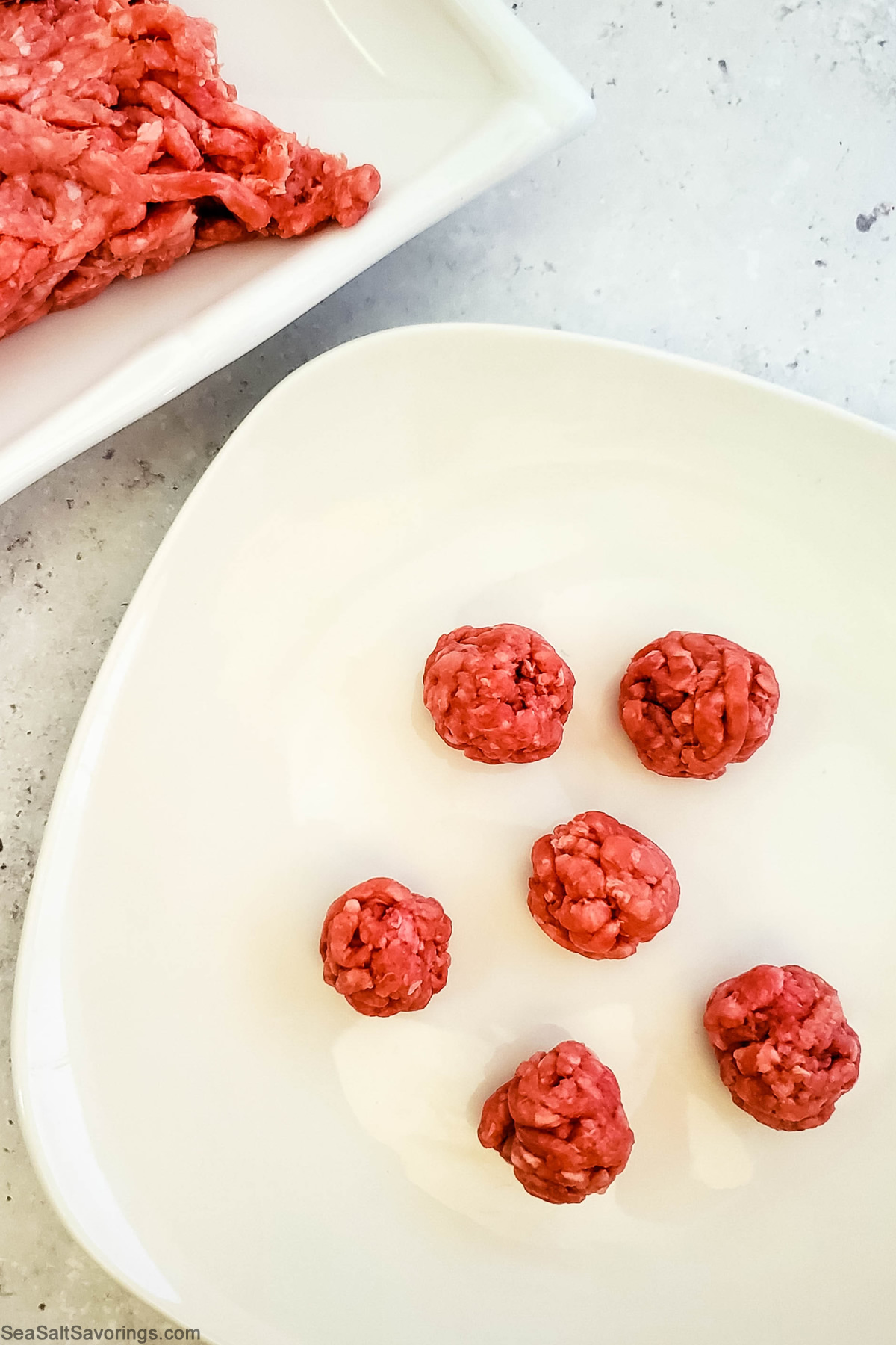 ground beef formed into small balls on a plate