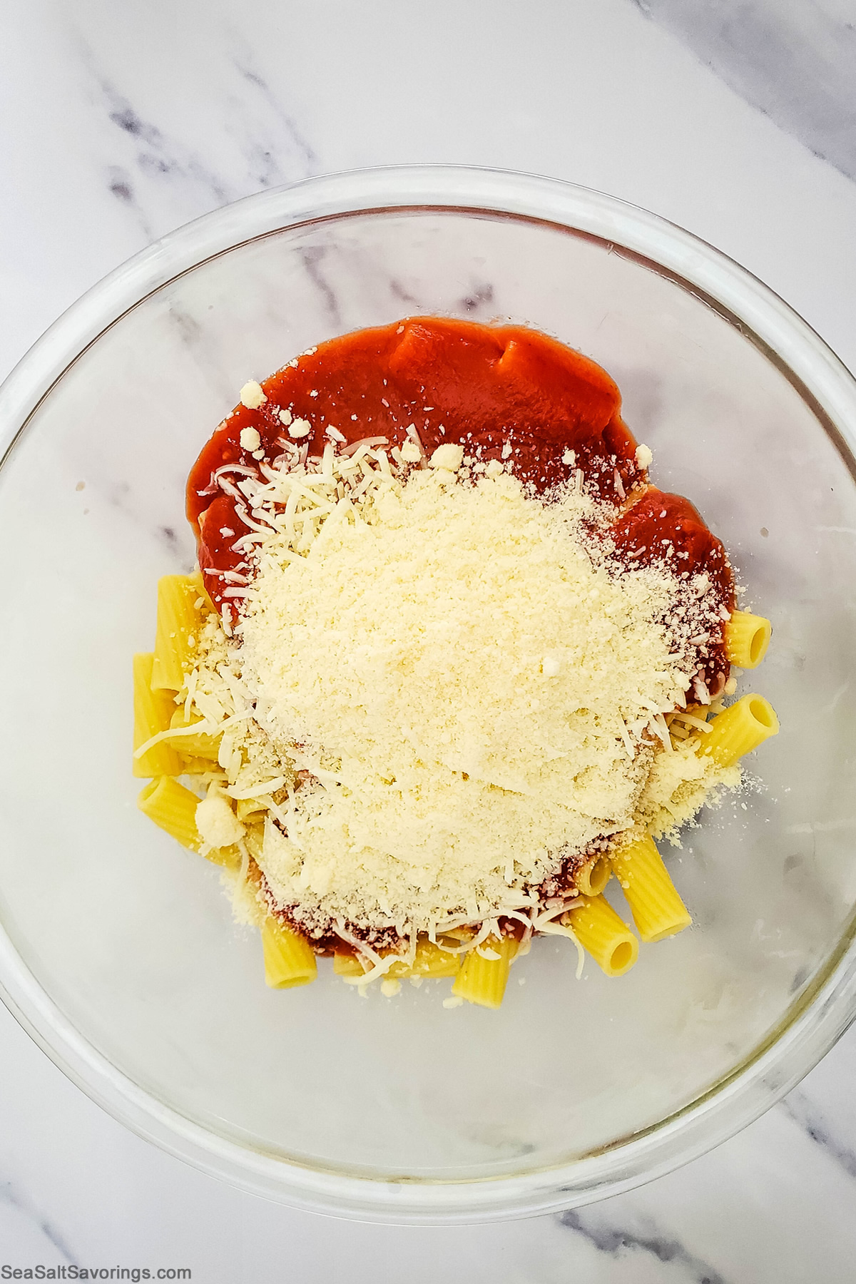 cheese noodles and sauce in a bowl ready to be mixed