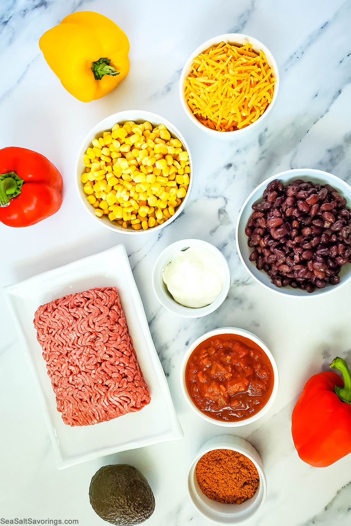 ingredients in bowls on a table for taco stuffed peppers