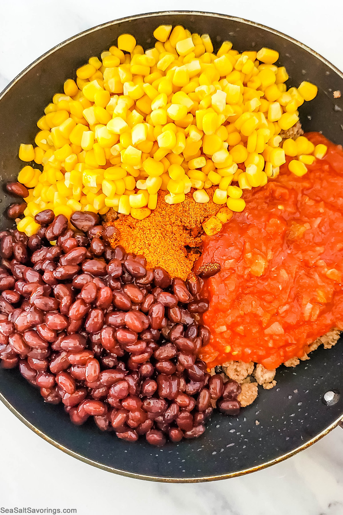 taco filling ingredients in a skillet ready to cook