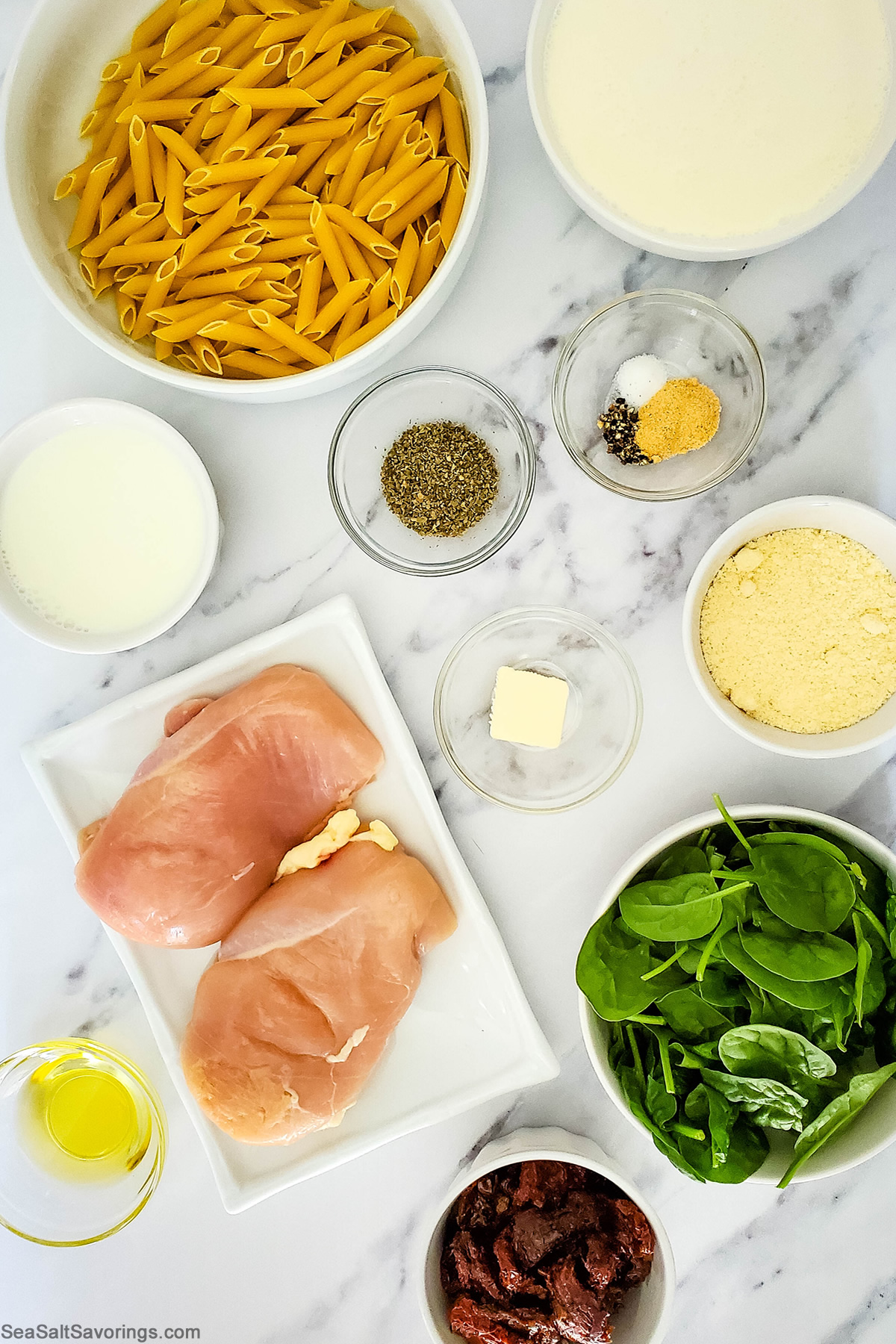 tuscan chicken ingredients in bowls on a table