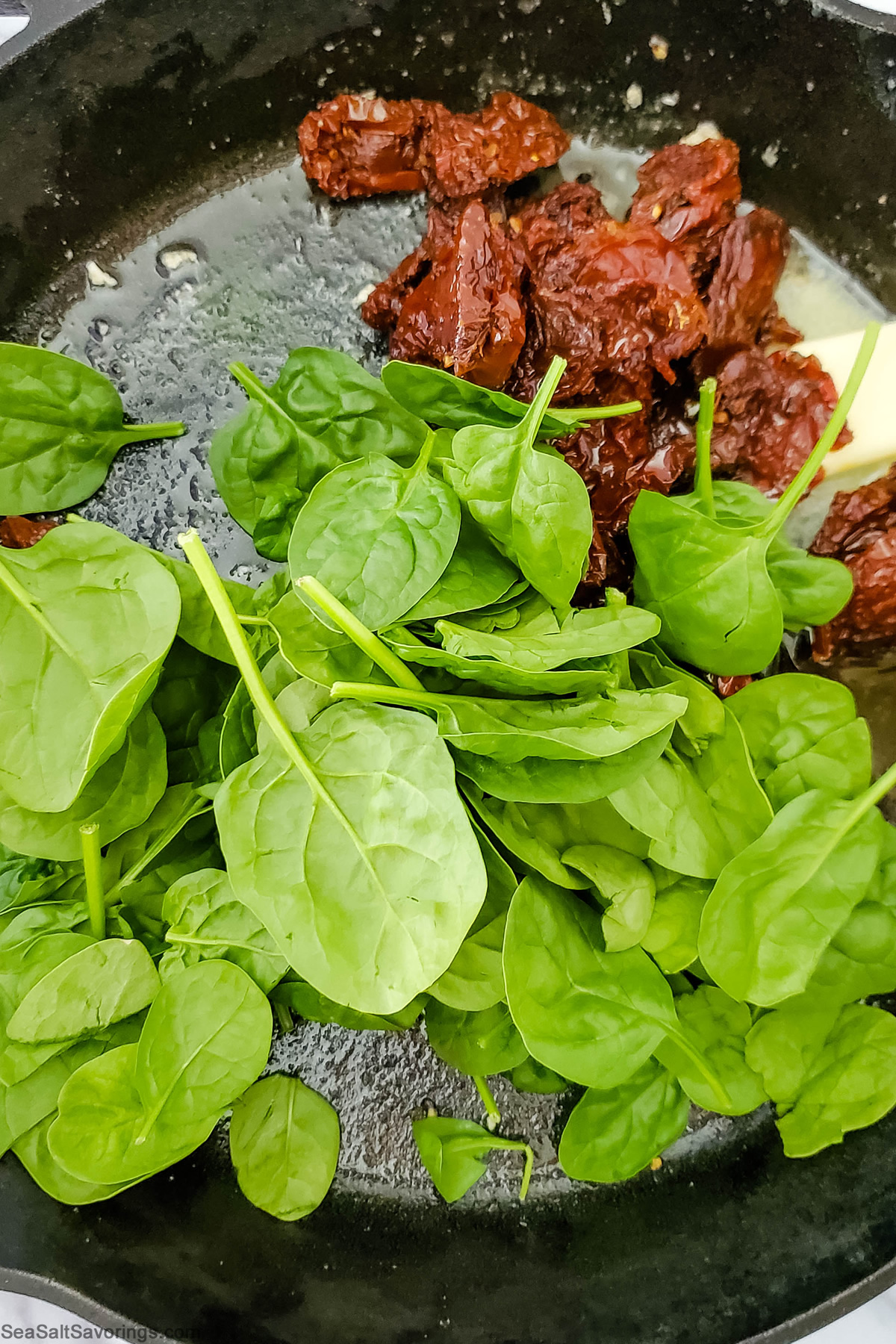 vegetables and butter placed in cast iron skillet