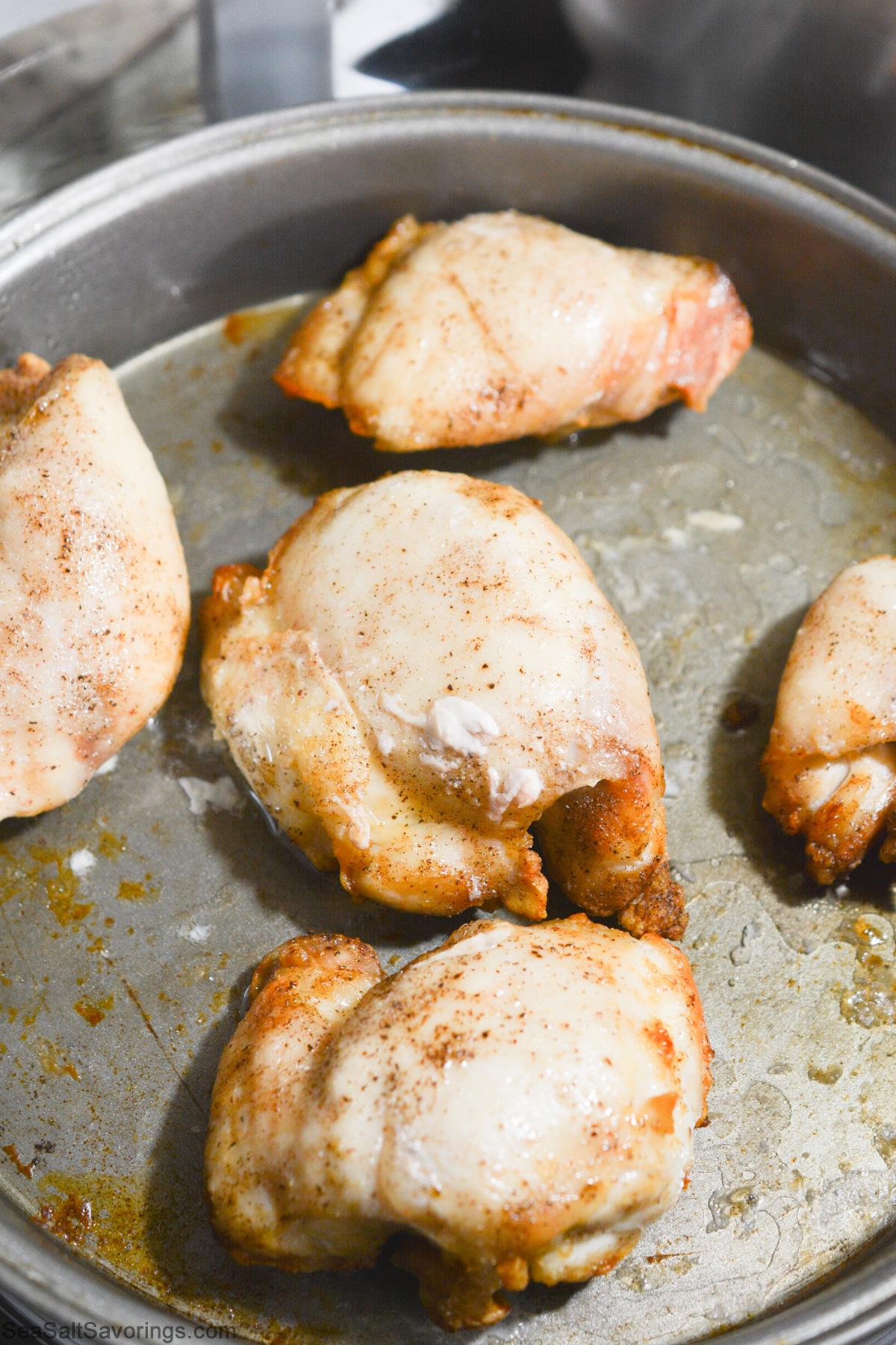 chicken thighs cooking and browning