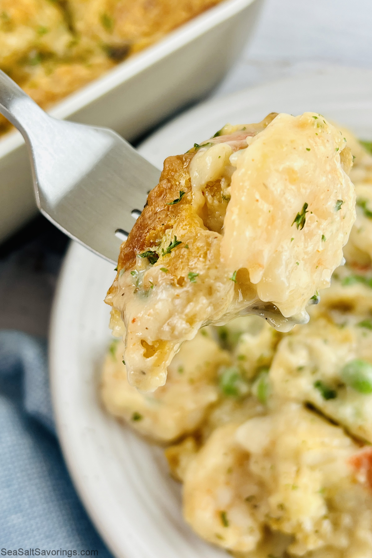 fork full of cheddar bay biscuit seafood bake