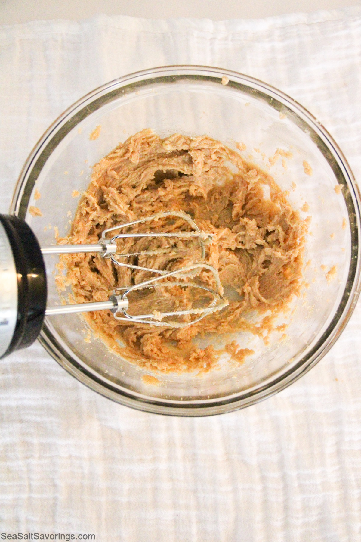 wet ingredients in glass bowl being blended together