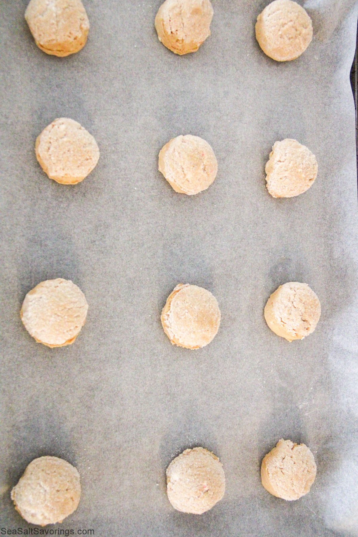 cookie dough formed and shaped and placed on a cookie sheet