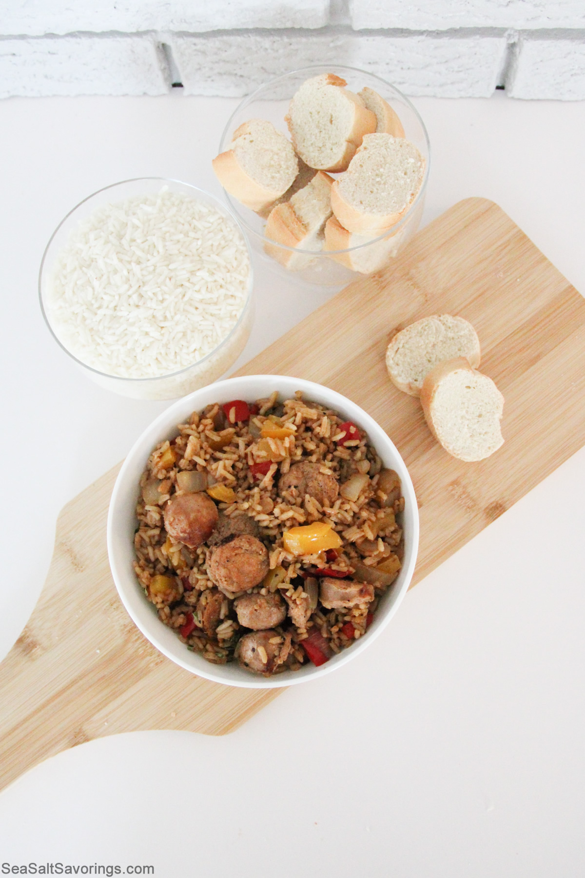 sausage skillet in a bowl on a cutting board with bread