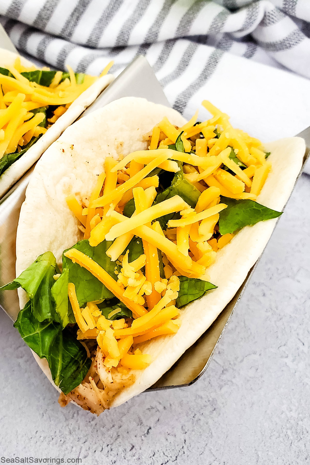 overhead view of a street taco filled with chicken and cheese