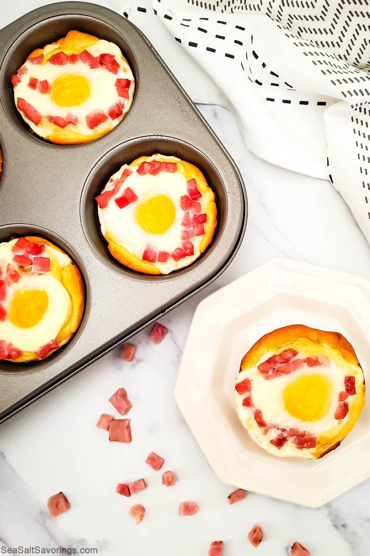 muffin tin with ham and egg biscuits cooked