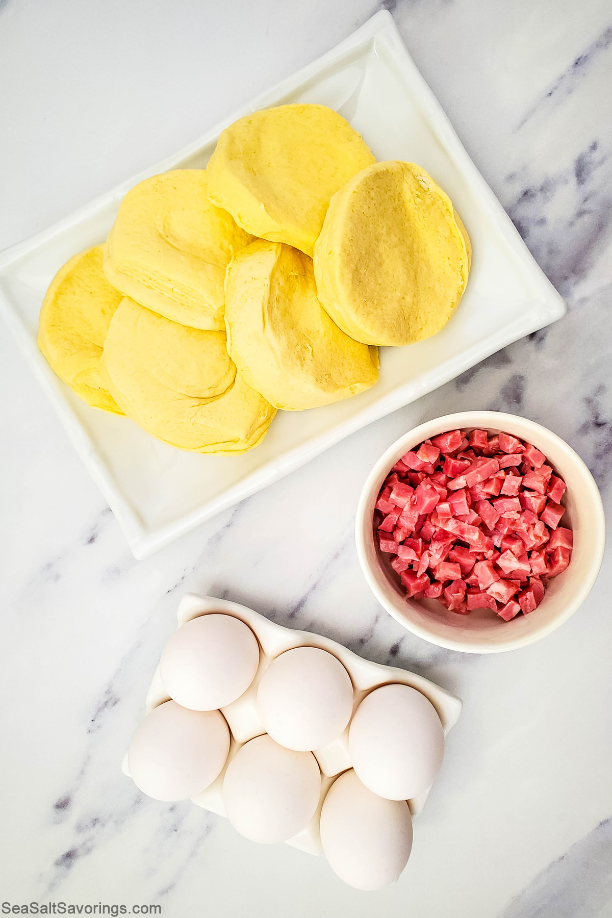 biscuits and ham and eggs on a table