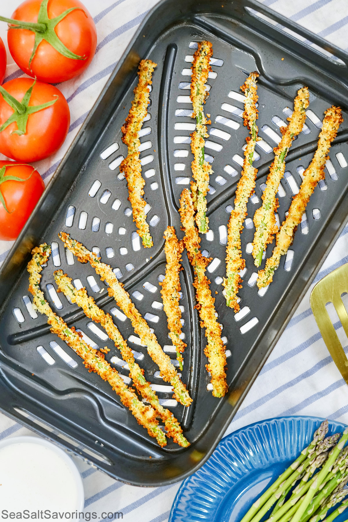 air fried asparagus laying in fry basket