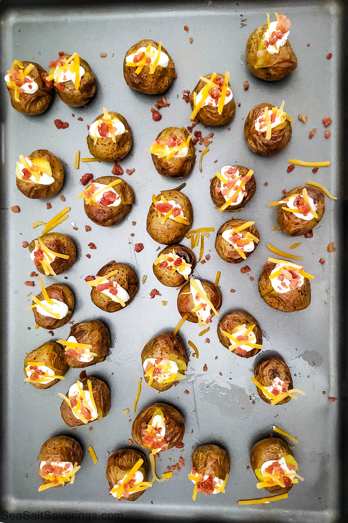 mini baked potatoes with toppings stuffed on top bacon and cheese