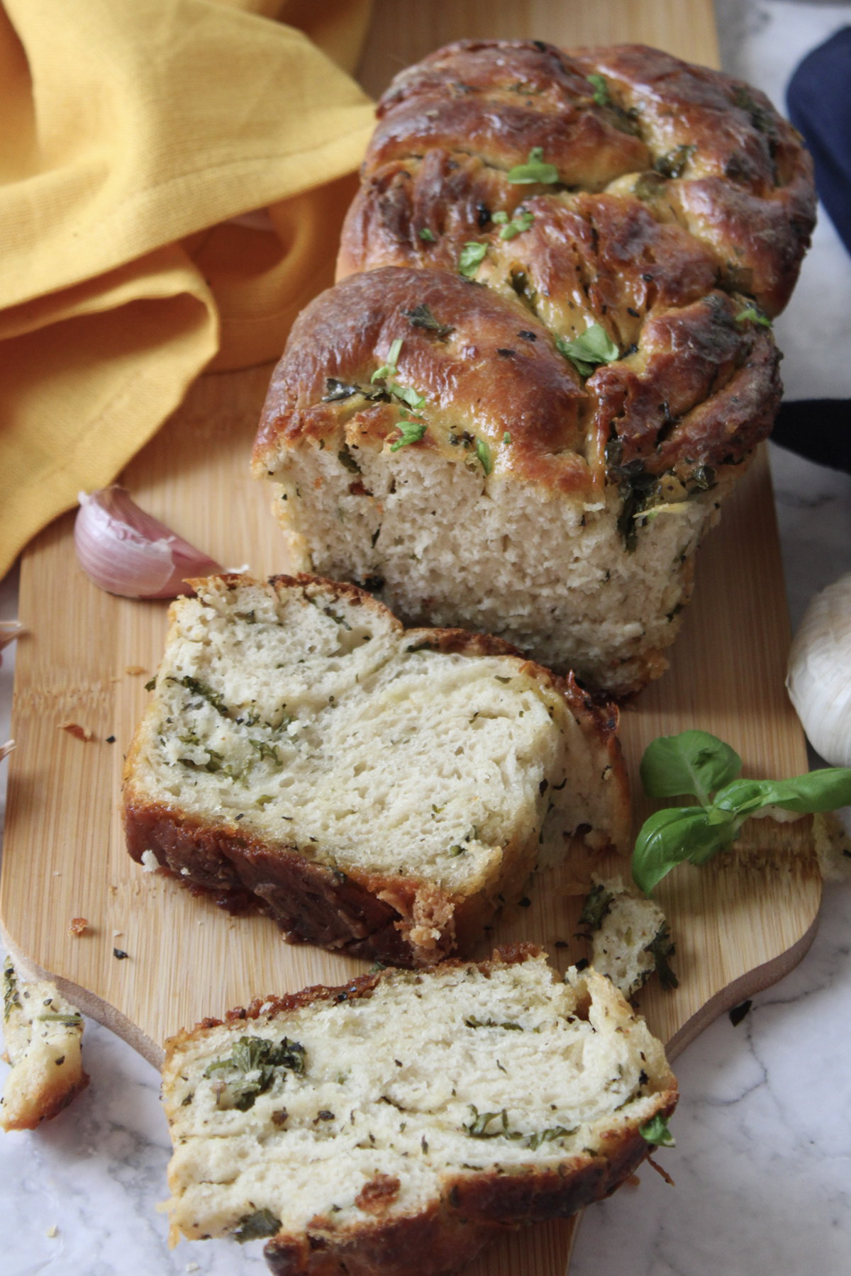 loaf of garlic swirl bread with a slice taken