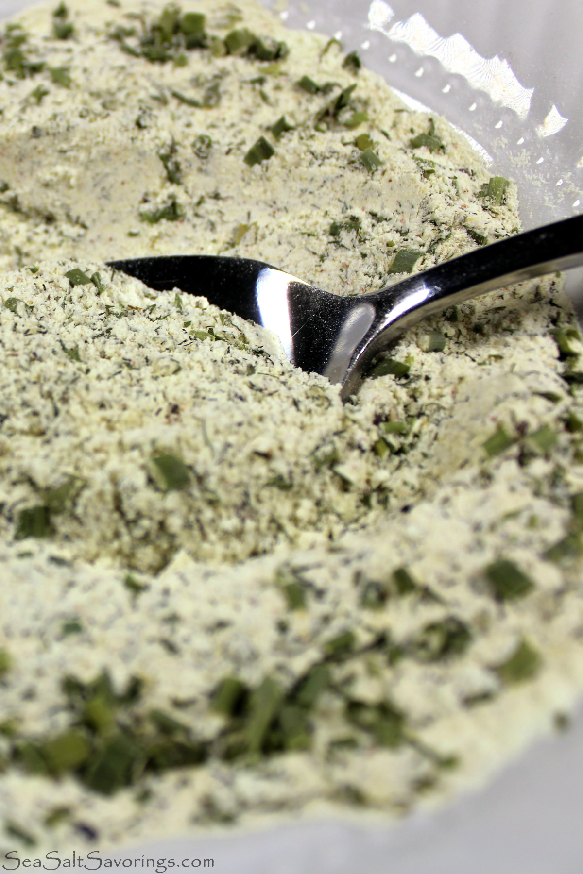 close up view of a spoon scooping into ranch seasoning