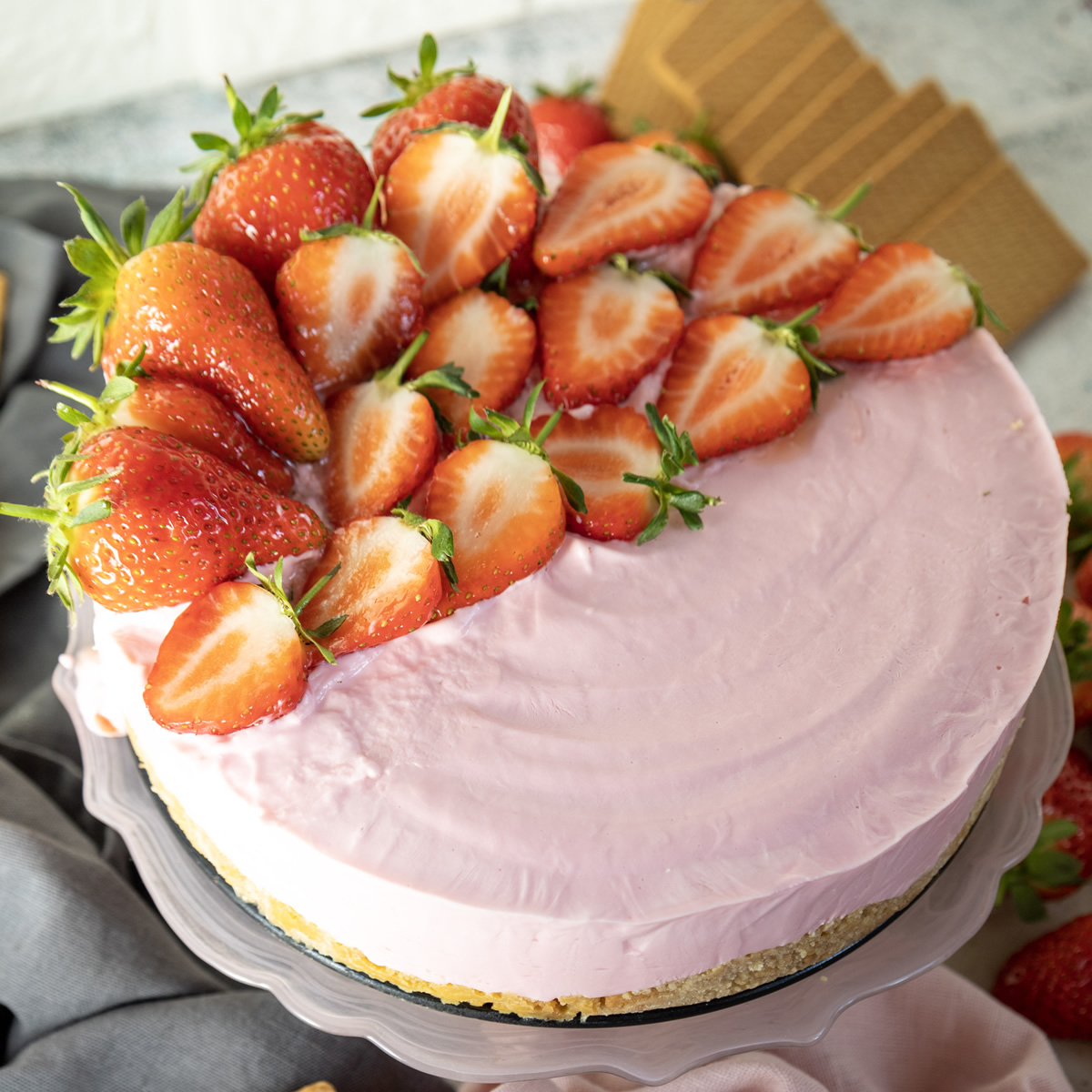 overhead view of a strawberry cheesecake with fresh strawberries on top