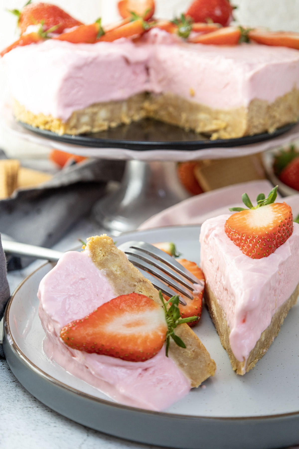 two slices of strawberry cheesecake on a plate