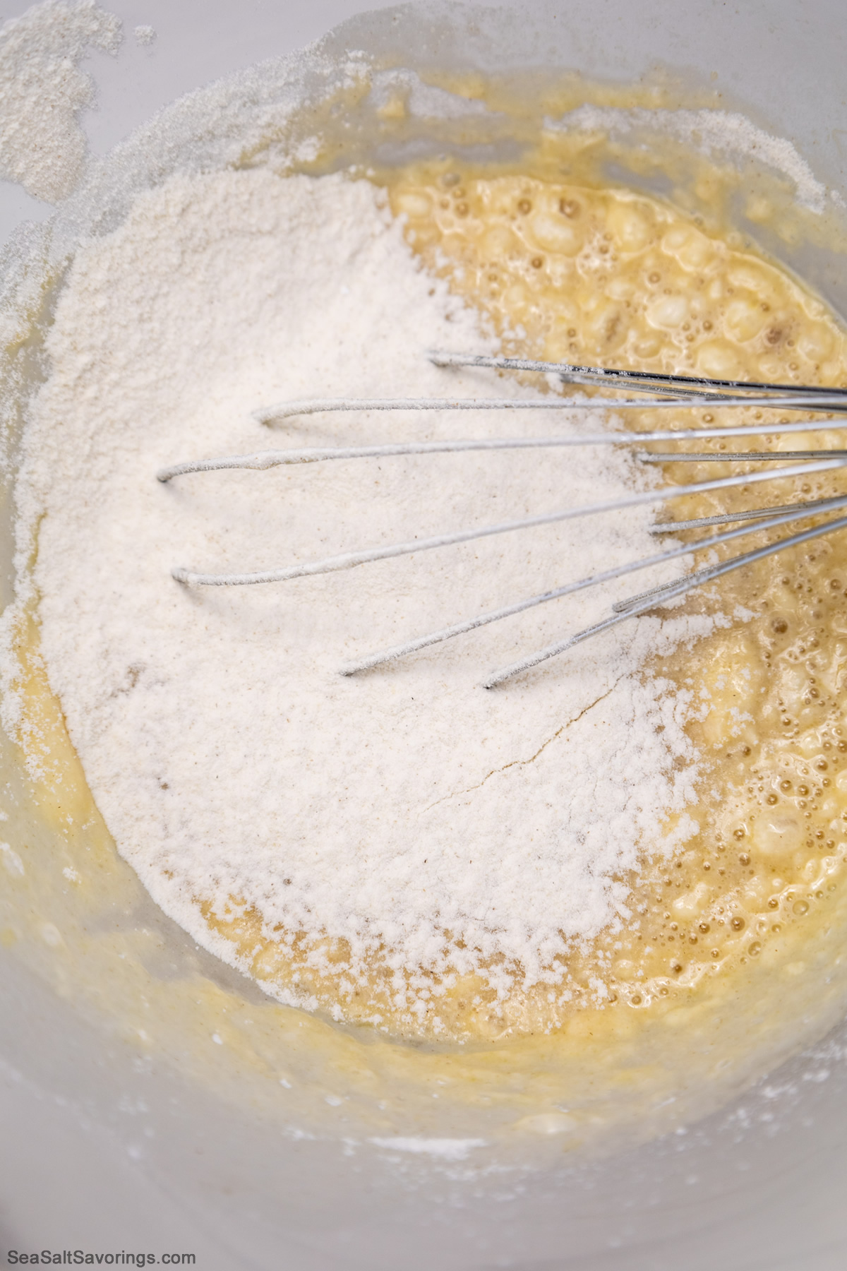 whisking flour into dough mixture