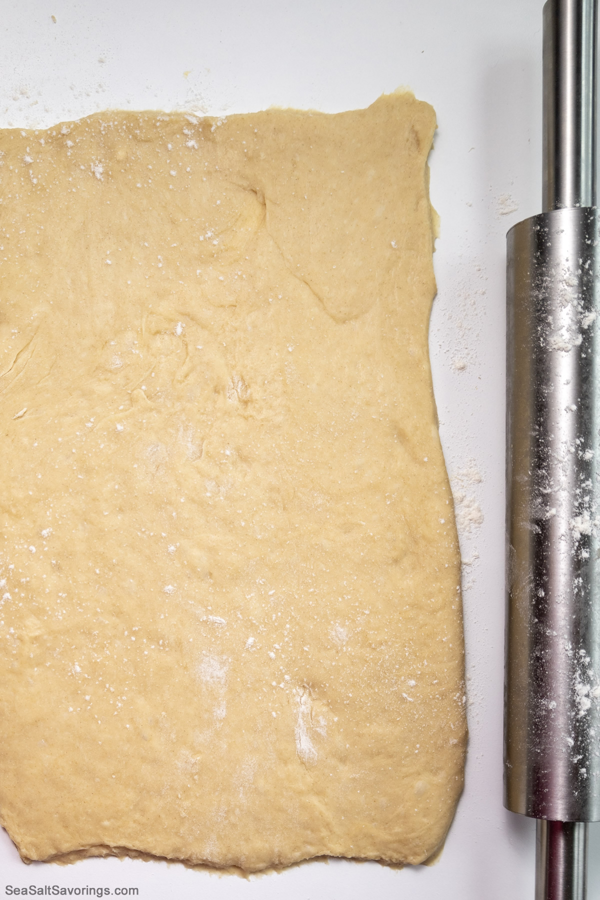 roller pin next to flattened dough