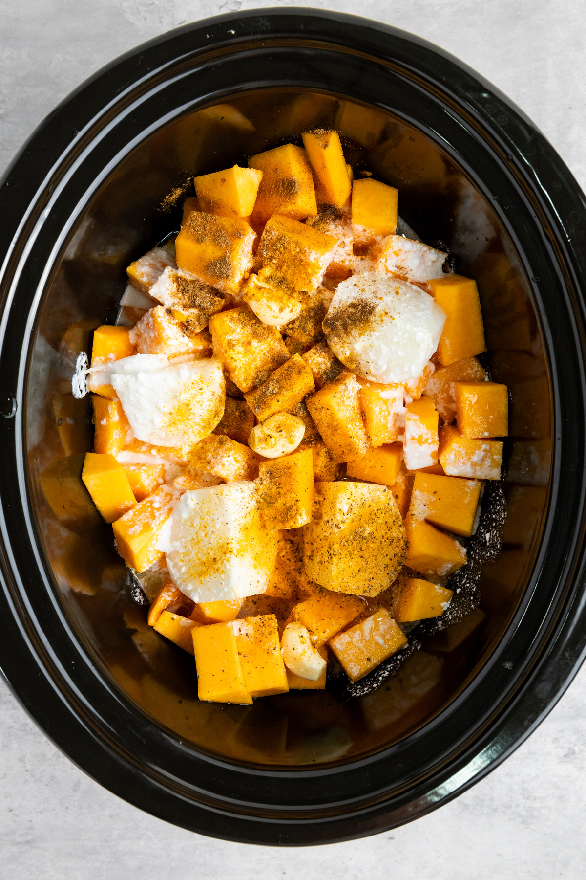 squash soup ingredients placed in slow cooker