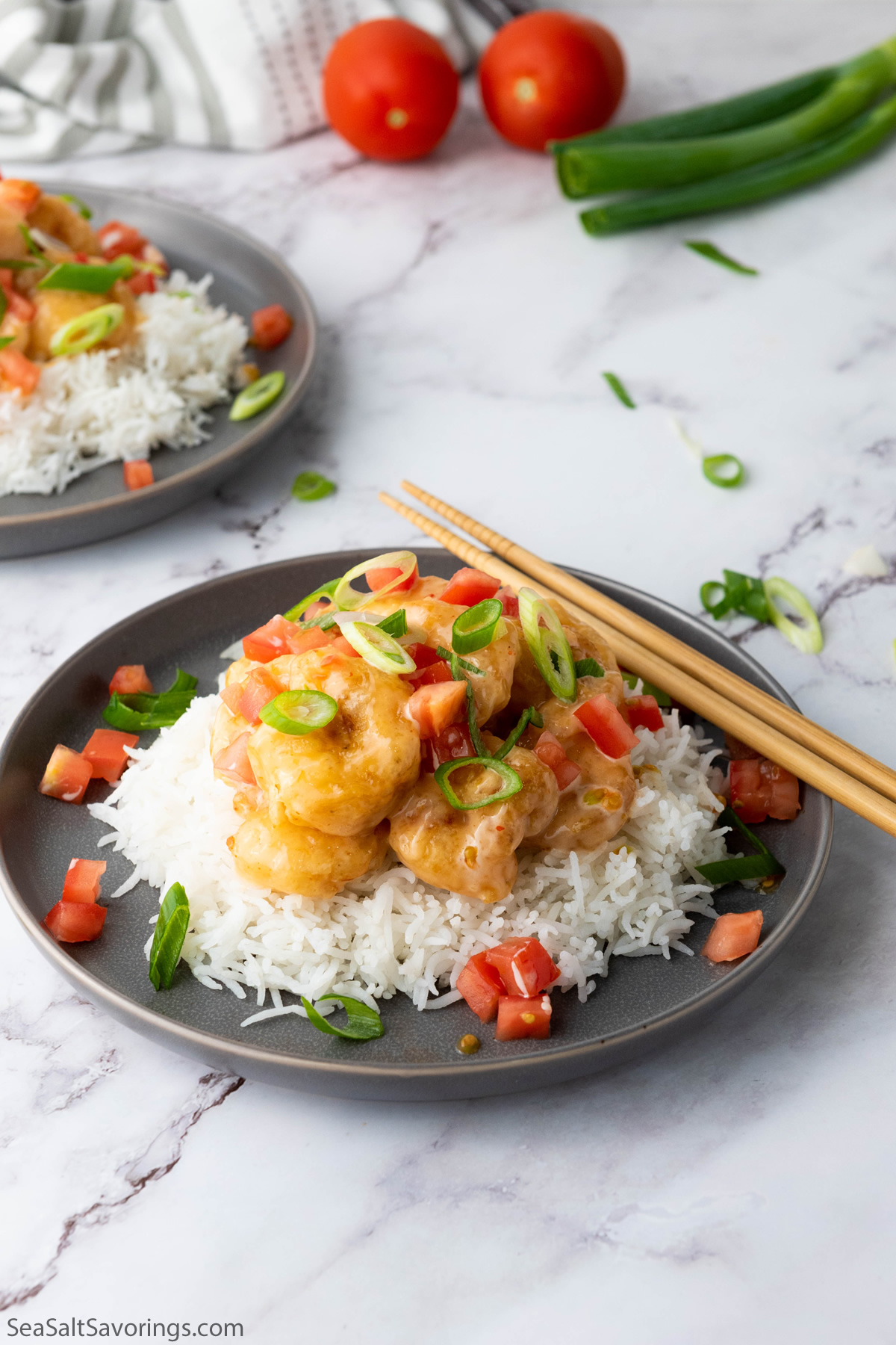 Bang Bang Shrimp over white rice in a bowl, showcasing the crispy shrimp topped with spicy, creamy sauce