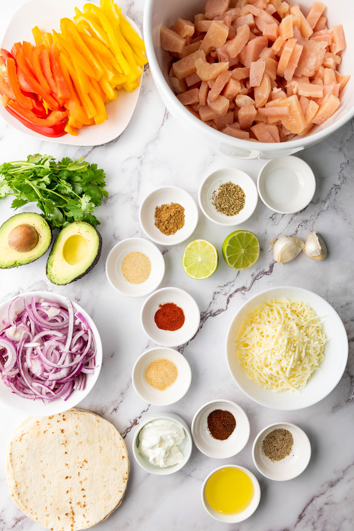 ingredients in cups and bowls for chicken fajitas