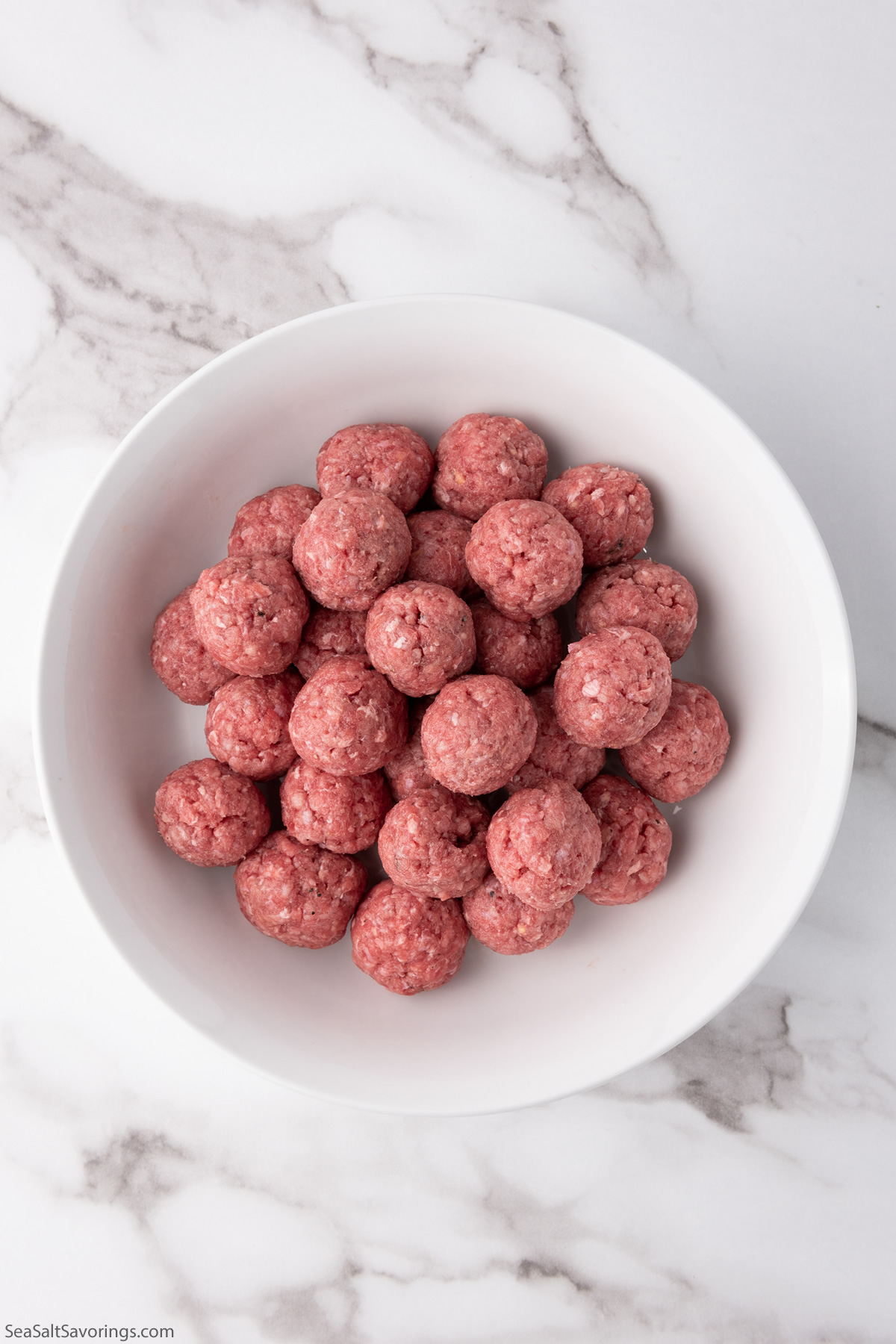 ground beef shaped into balls in a bowl