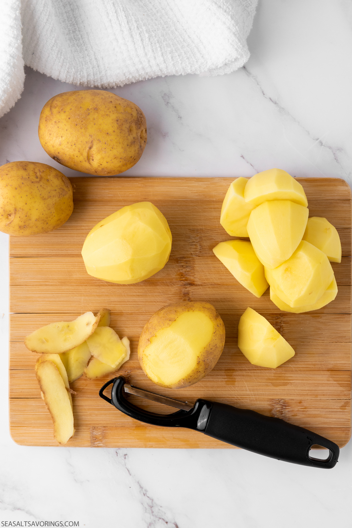 cutting board with sliced potatoes