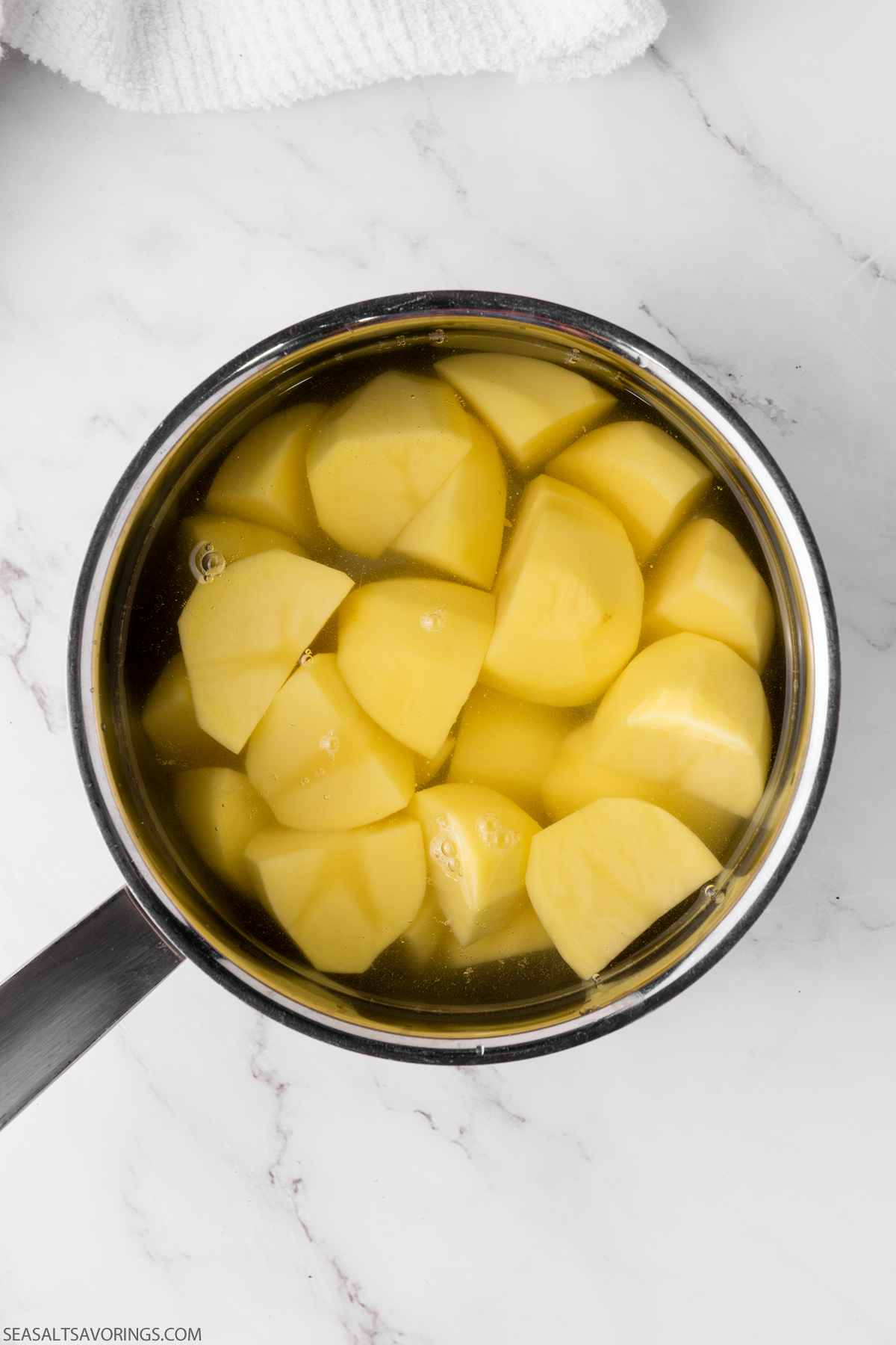 pot of boiled and chopped potatoes
