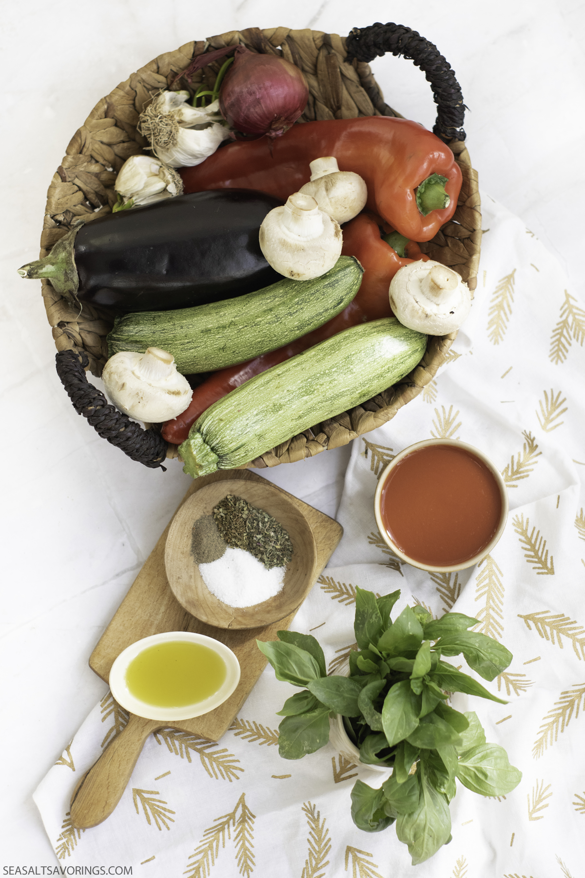 basket of vegetables and small bowls of spices on a table