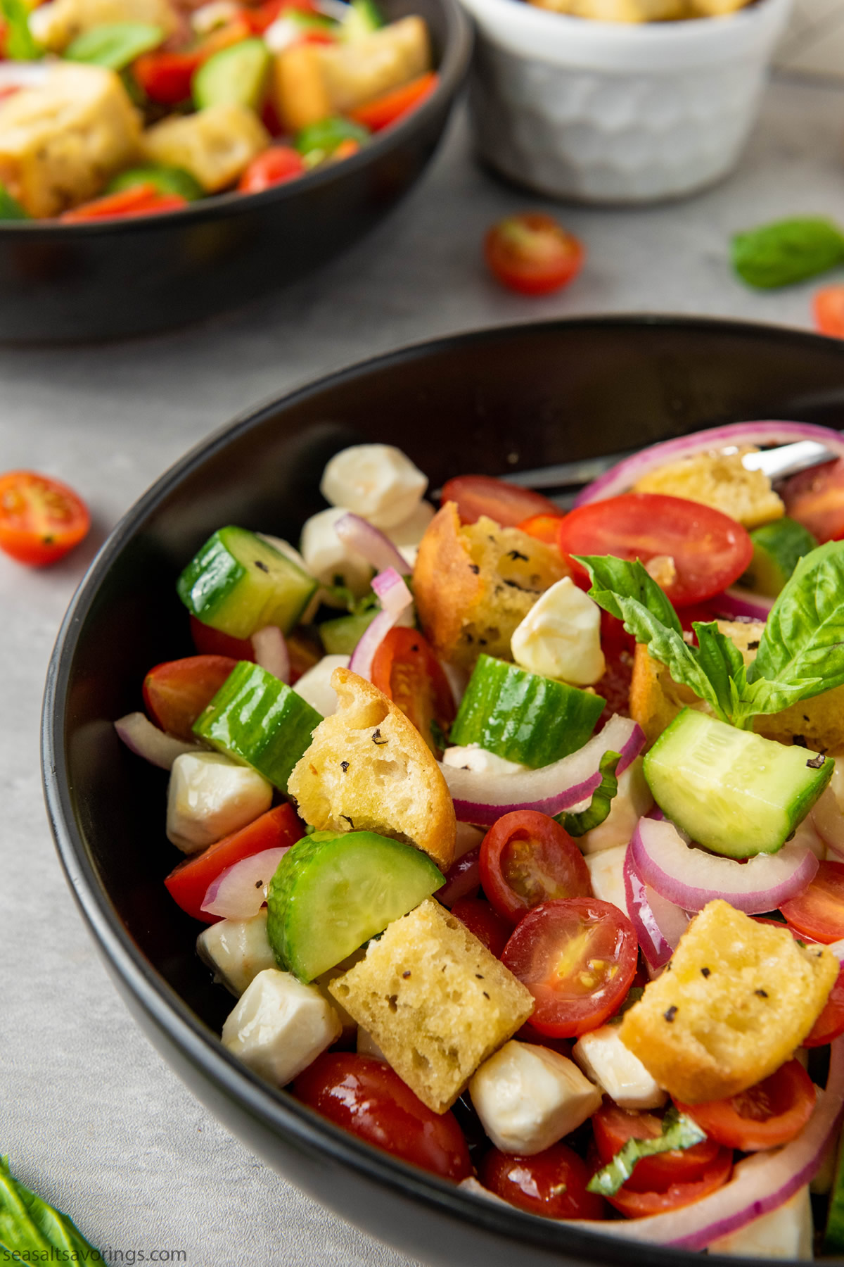 bowl of salad with mixed vegetables and ciabatta bread cubes