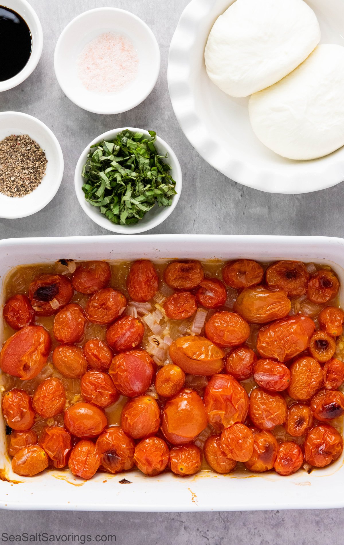 cooked tomatoes in pan next to raw ingredients