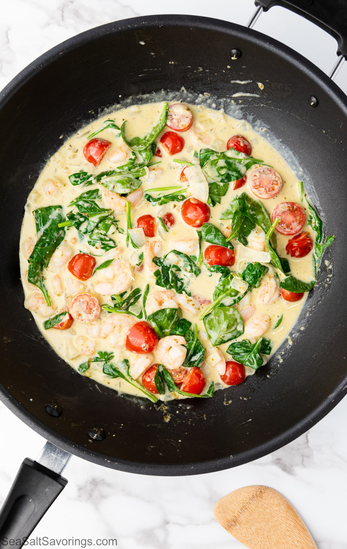 all ingredients for spaghetti scampi cooking in pan