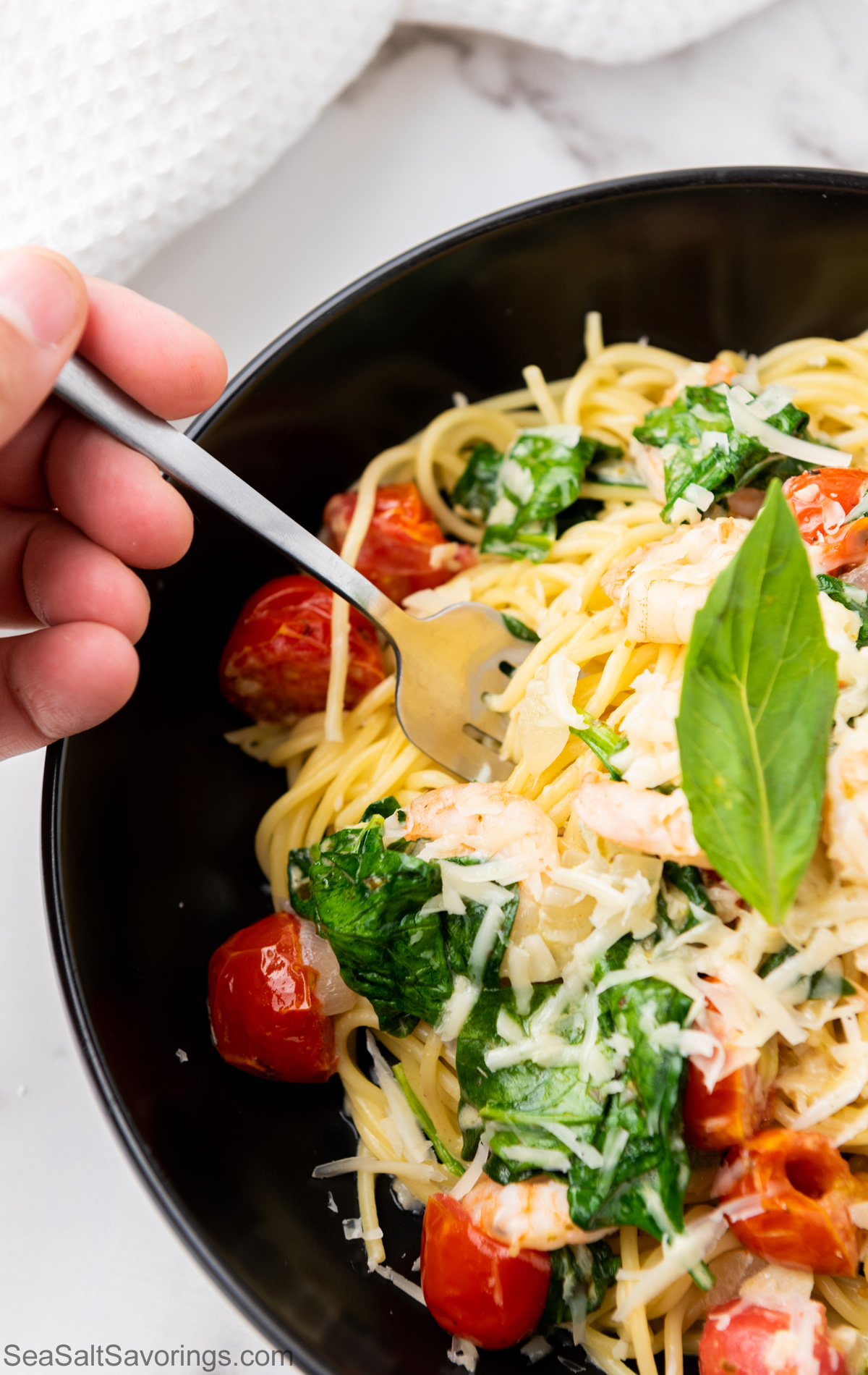 fork taking a scoop of spaghetti scampi