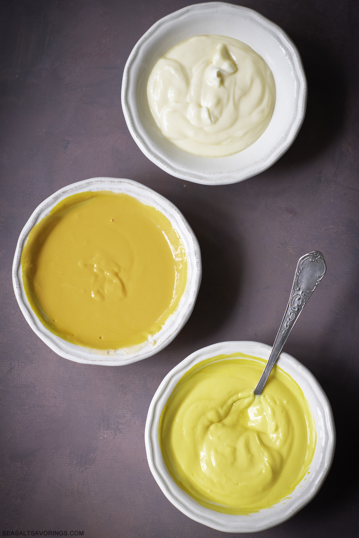 three colors of batter in bowls ready to be scooped