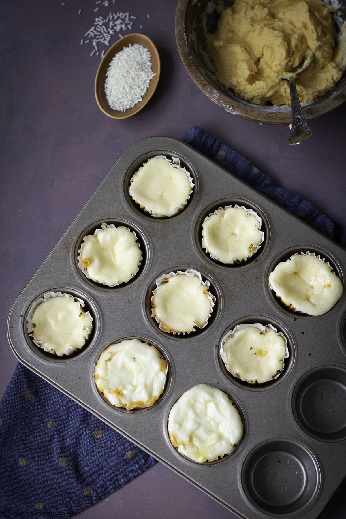 baking sheet with the freshly baked mini cheesecakes