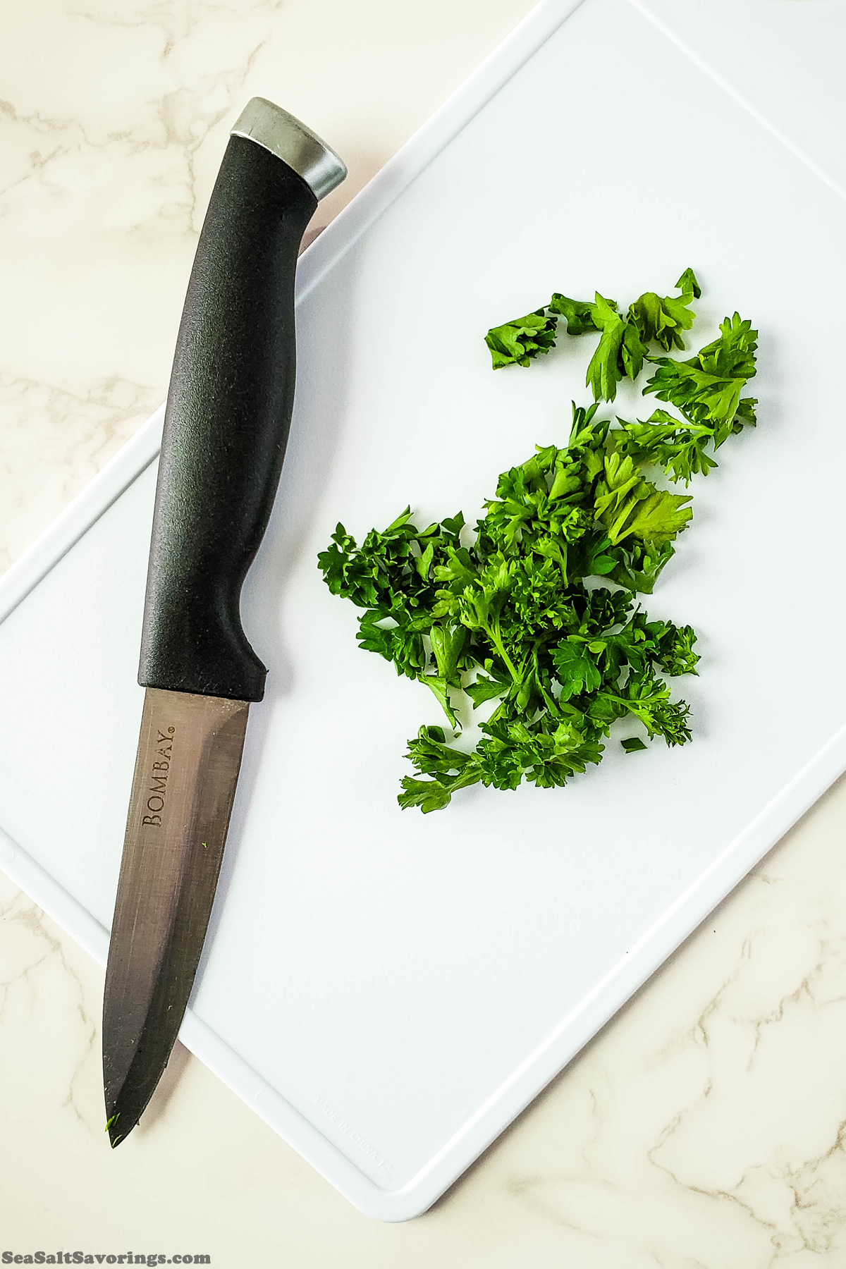 chopping parsley on cutting board