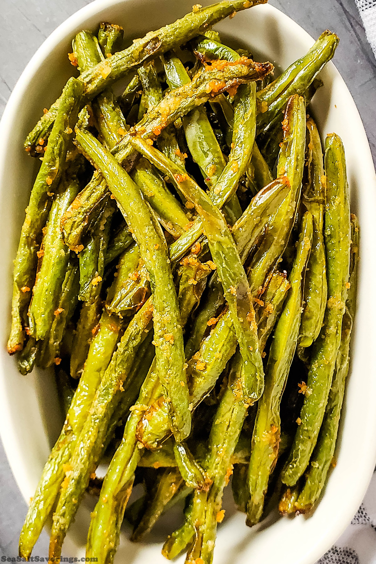 big oval bowl of garlic parmesan green beans