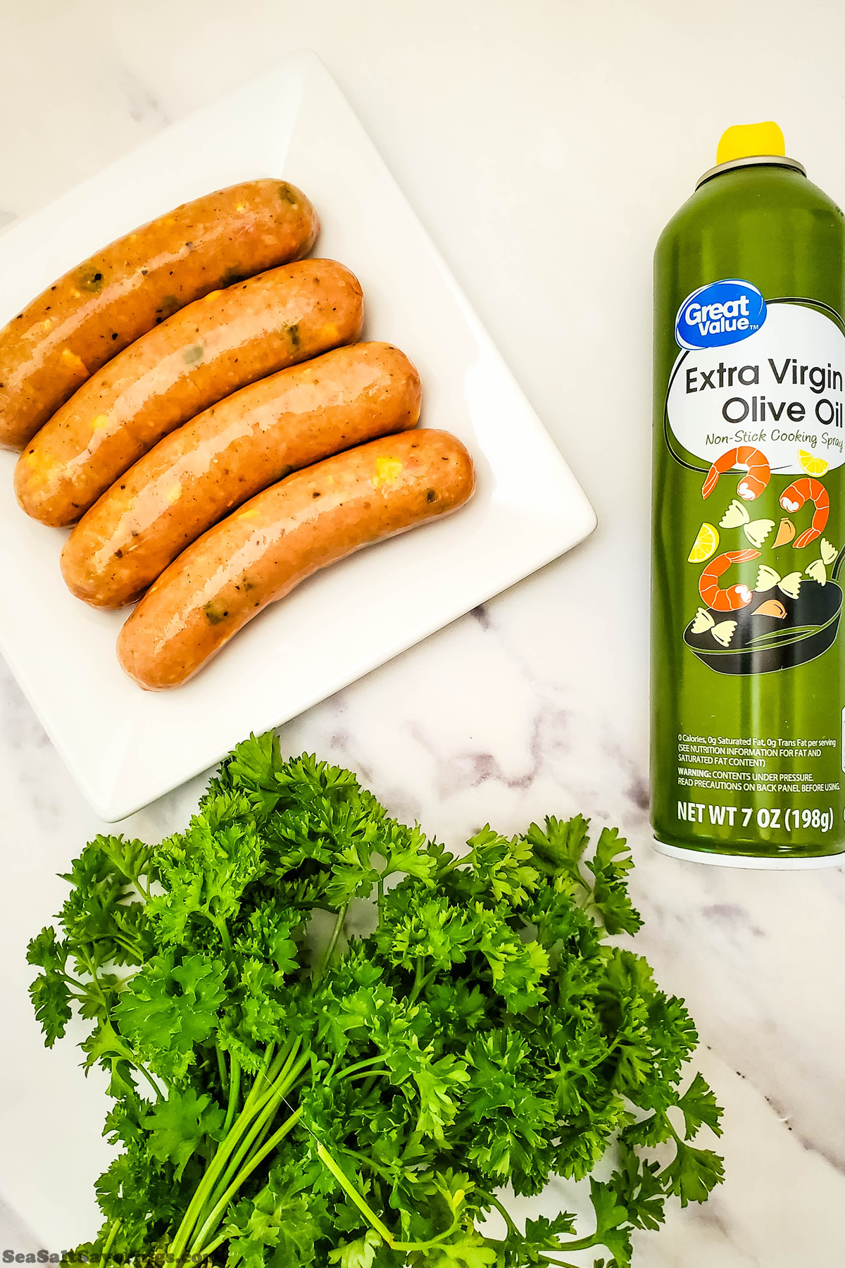 simple ingredients for sausage bites appetizer, including the chicken sausages and spray oil and parsley garnish