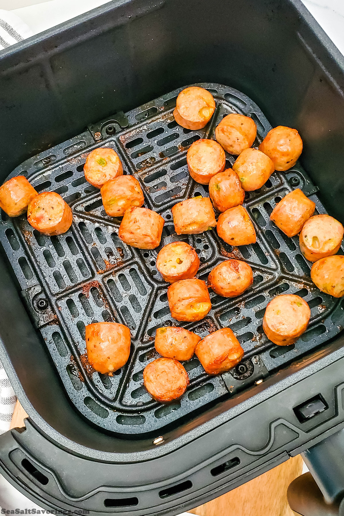 single layer of air fried chicken sausage pieces fully cooked