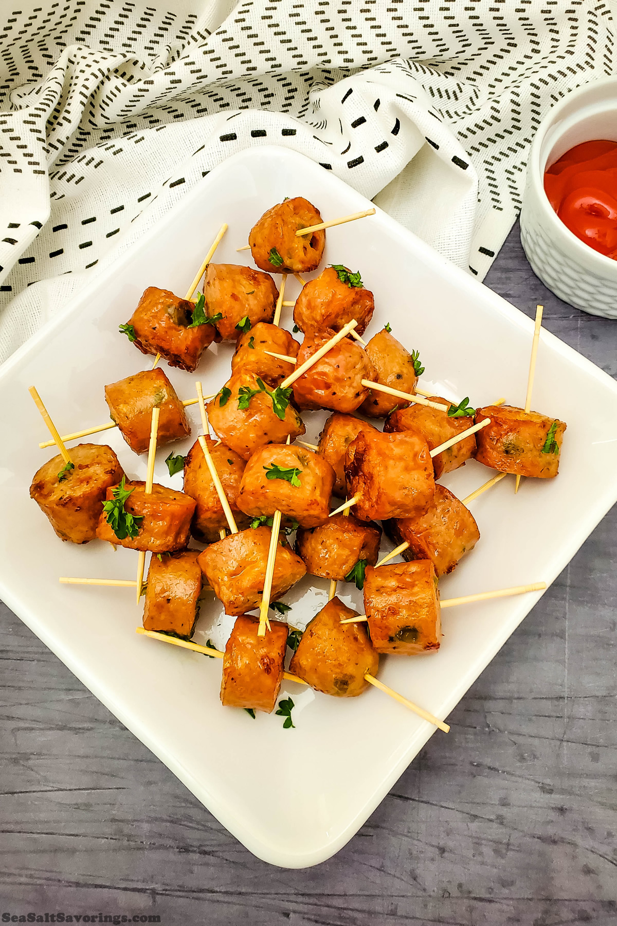 plate of chicken sausage bites on toothpicks