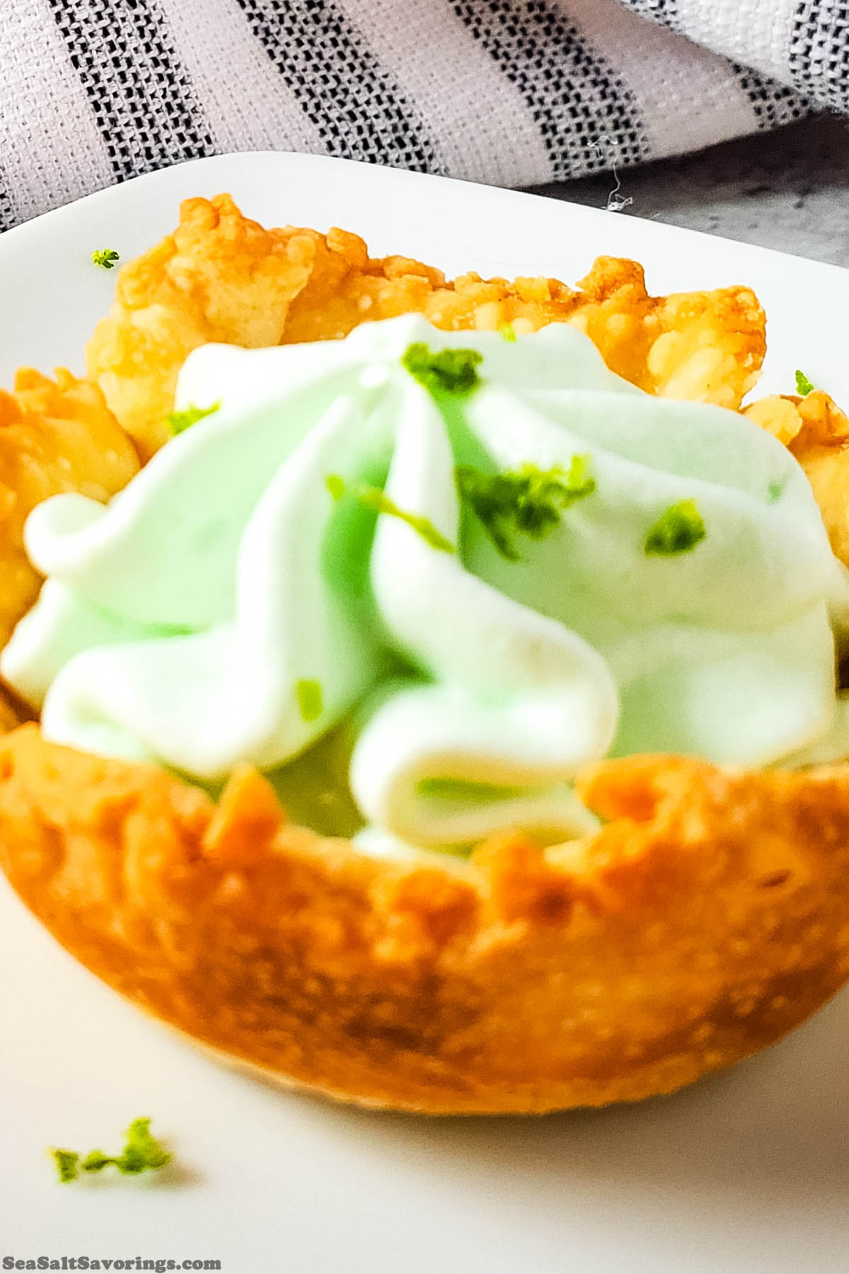 close up view of a key lime pie bite, showing the creamy texture of the filling and crispy crust