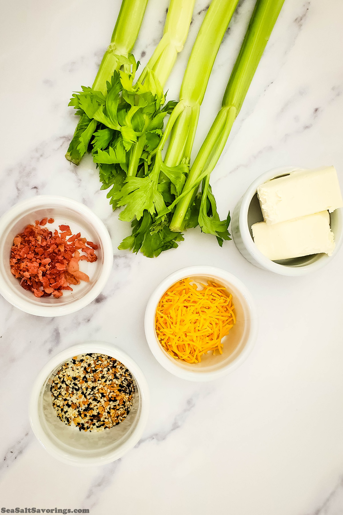 ingredients for stuffed celery on a table including bacon bits and cheese